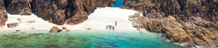 Two people on Pearl Bay Beach in the Whitsundays