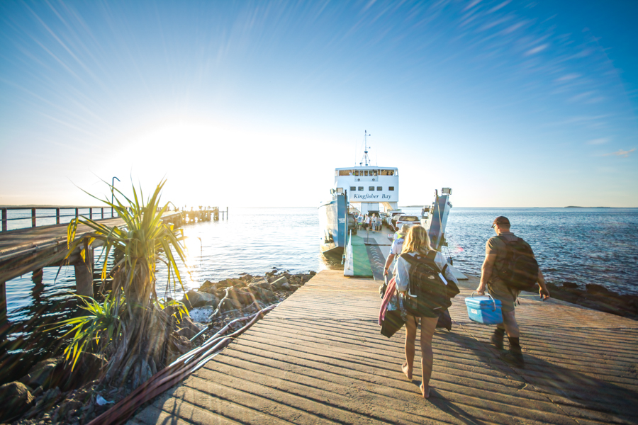 travellers with bags walking on the kingfisher bay ramp