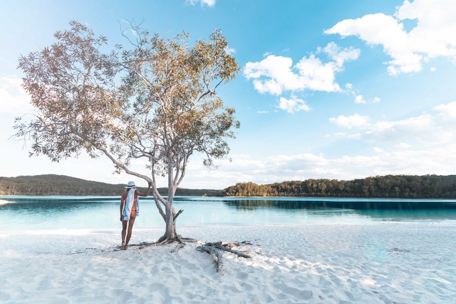 girl standing next to Lake Mckenzie calm and peaceful