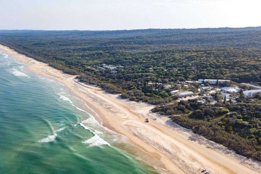 K'gari Coastline 75 Mile Beach surrounded by rainforest on k'gari