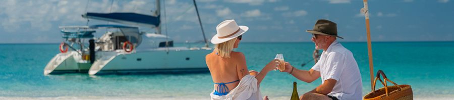 Whitsunday Blue couple having a picnic on whitehaven beach