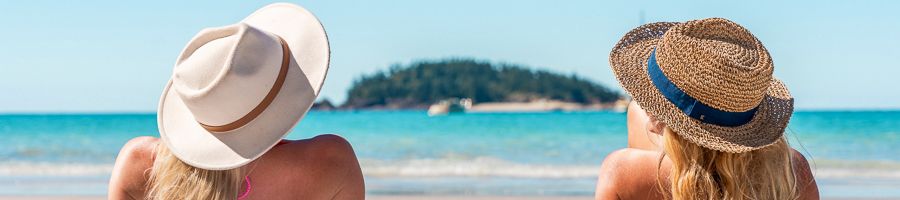 Two women on Whitehaven Beach relaxing