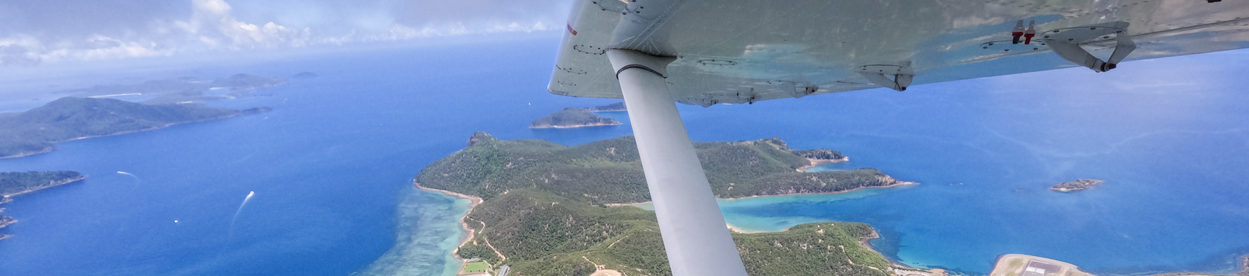 a view of the whitsunday islands from a plane window