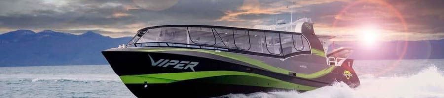 A black and green boat at sunset 