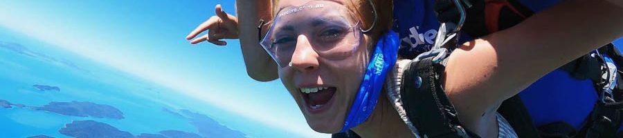 A woman with red hair skydiving