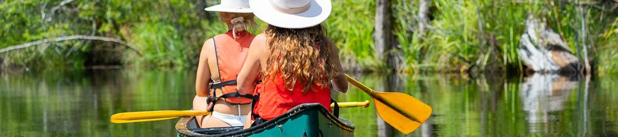 Canoeing K'gari two girls in hats on a canoe tour around kgari