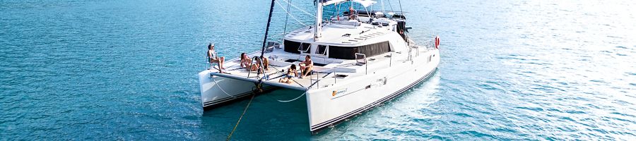 Whitsunday Catamaran sailing A white catamaran Getaway on the Whitsunday waters