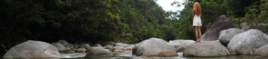 Woman standing on rock at freshwater creek