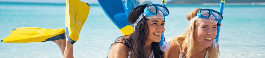 Snorkel Whitehaven Beach girls lying on the beach with snorkel gear