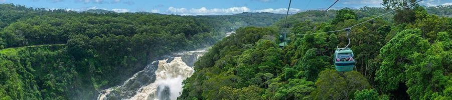 Skyrail gliding past heavily flowing Barron Falls, Cairns
