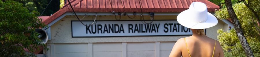 Person wearing a hat standing outside of the Kuranda Railway Station
