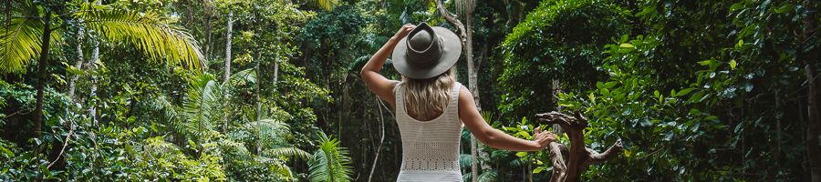 K'gari Central Station A woman in the K'gari forest in a hat