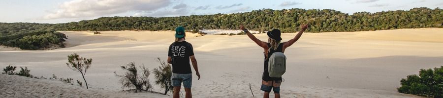 Two backpackers in the sand on K'gari