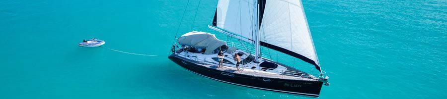sailing ship cruising over turquoise waters at whitehaven beach