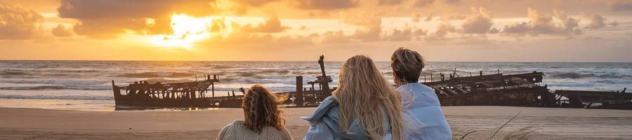 Sunrise on K'gari three girls watching sunrise over maheno shipwreck