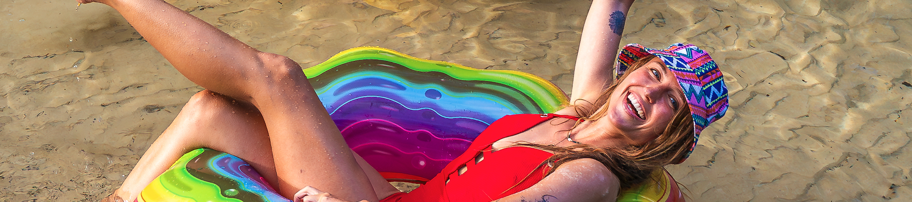 a woman on a blow up ring floating down a river