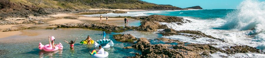 Group of travellers in floaty toys at Champagne Pools