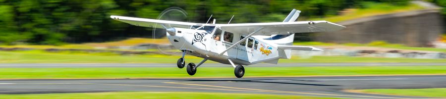 Ocean Rafting's Scenic Flight A scenic flight plane taking off on a small runway