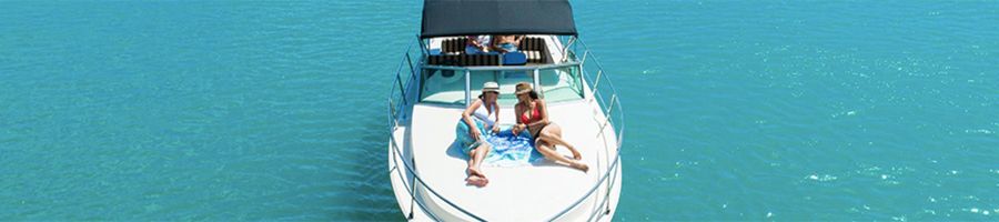 Salty Private Charter couple lounging on sundeck of a private yacht in the ocean