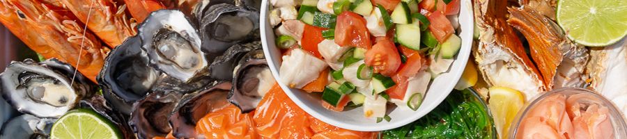Seafood platter with prawns, oysters, bug, ceviche, salmon, lime and more