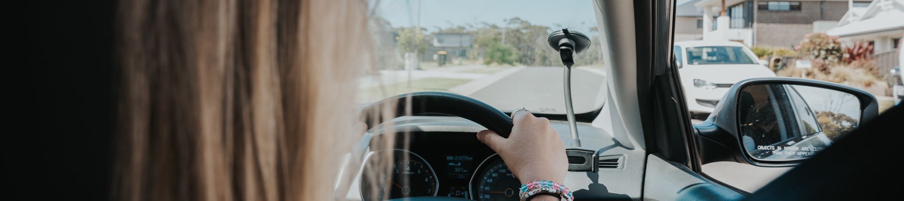 A woman in the drivers seat of a car