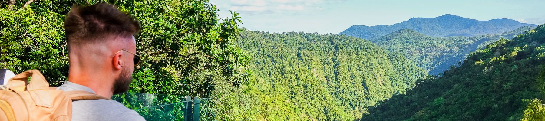 A man at a lookout overlooking a waterfall