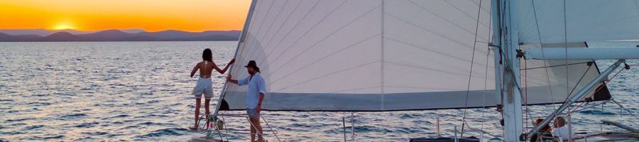 MiLady Sunset Sail couple standing on the front of milady ship at sunset