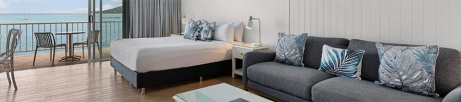 Coral Sea Resort bed and living area in a suite at coral sea resort