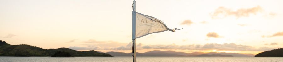 Alani Yacht a flag on the back of a yacht that says 'Alani'