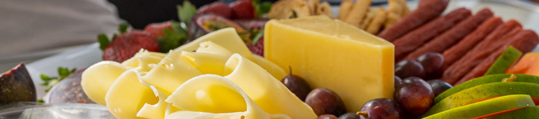 Cheese, fruits, crackers and snacks antipasto board