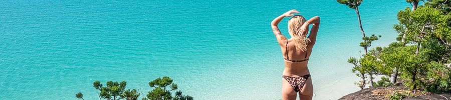A woman gazing out at clear blue waters
