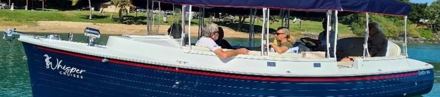 A couple sitting on board Whisper's turtle spotting cruise boat in Airlie Beach