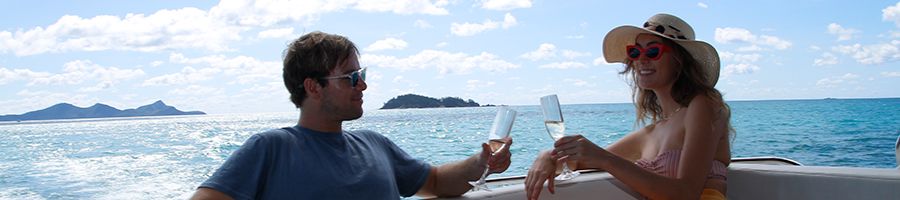 MV Alfie Relaxing Relaxed couple cheersing champagne onboard Alfie