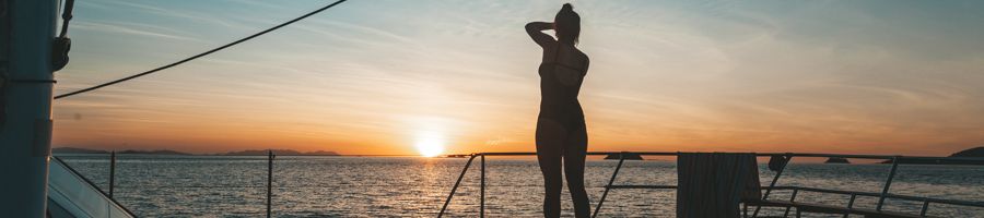 Sunset A woman's silhouette standing against an orange sunset