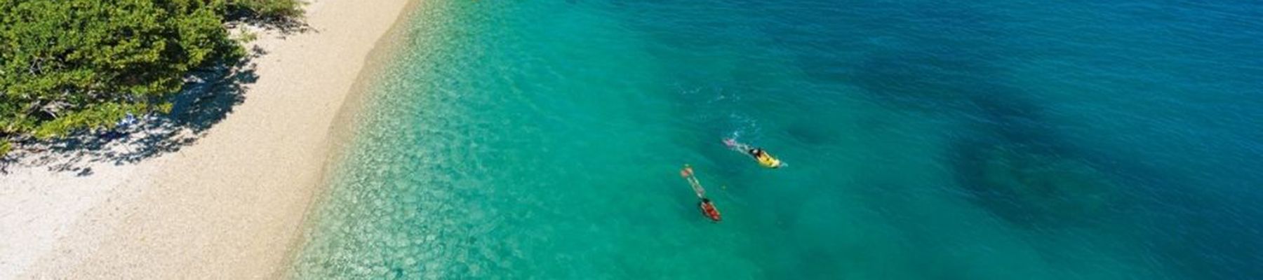 Couple snorkelling off the blue waters of Nudey Beach, Fitzroy Island