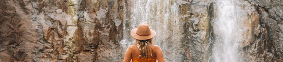 Cedar Creek Falls, Whitsundays Creek to Cape Day Tour Person wearing a hat at Cedar Creek Falls