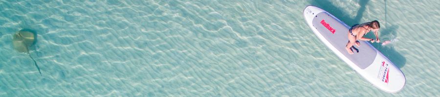 SUP Whitsundays SUP in the cleaar blue waters of Whitehaven Beach