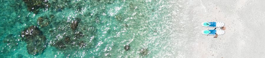Two paddleboards lying on Blue Pearl Bay, Whitsundays