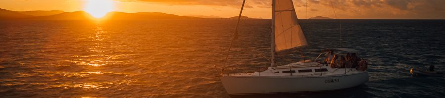 Domino sailing at sunset Domino sailing boat in the Whitsunday waters