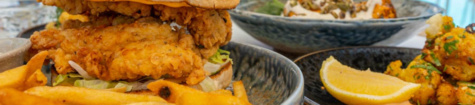Burger and chips, with salad on a plate