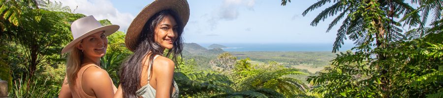 Two women wearing hats at a Cape Tribulation scenic lookout