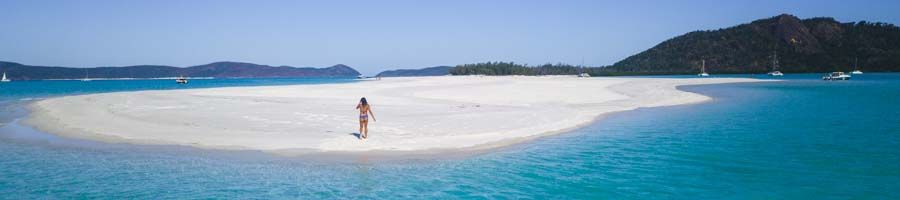 person walking on whitehaven beach