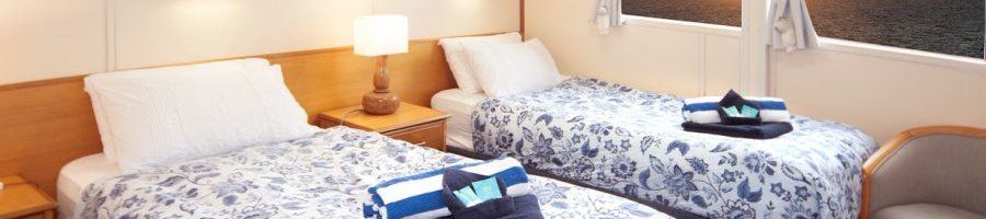 Two single beds in a Stateroom on Reef Encounter vessel