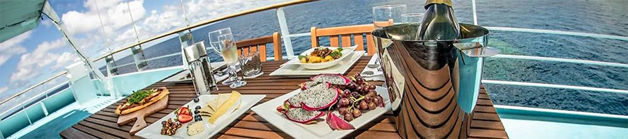 Selection of cheeses, fruits and champagne aboard Top Deck Club Reef Encounter