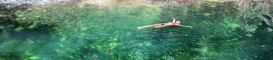 girl floating in creek