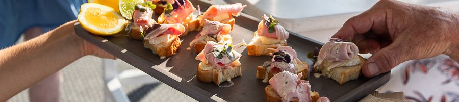 Explore Menu serving tray of canapes on a whitsunday boat