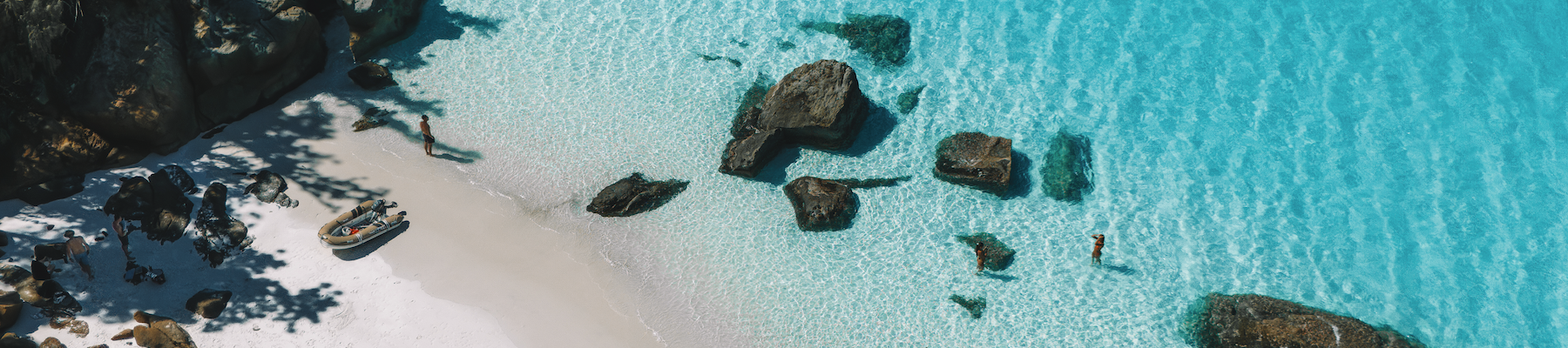 A shot of a beach with turquoise blue waters