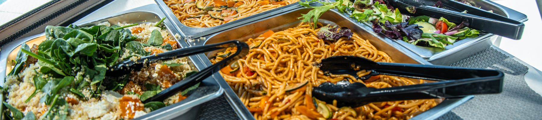 Lunch On Viper a close up of a buffet selection of pastas and salads
