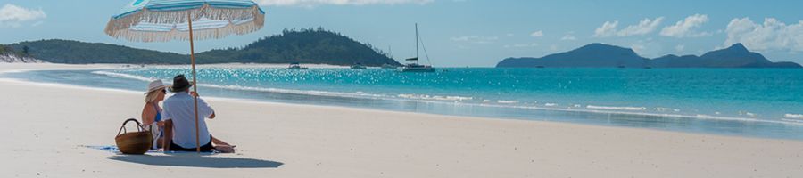 Whitehaven Beach, Whitsundays A Whitehaven Beach couple under an umbrella