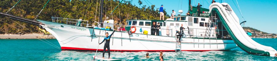 New Horizon Excursion Whitsundays New Horizon boat with kids SUPing, sliding and snorkelling